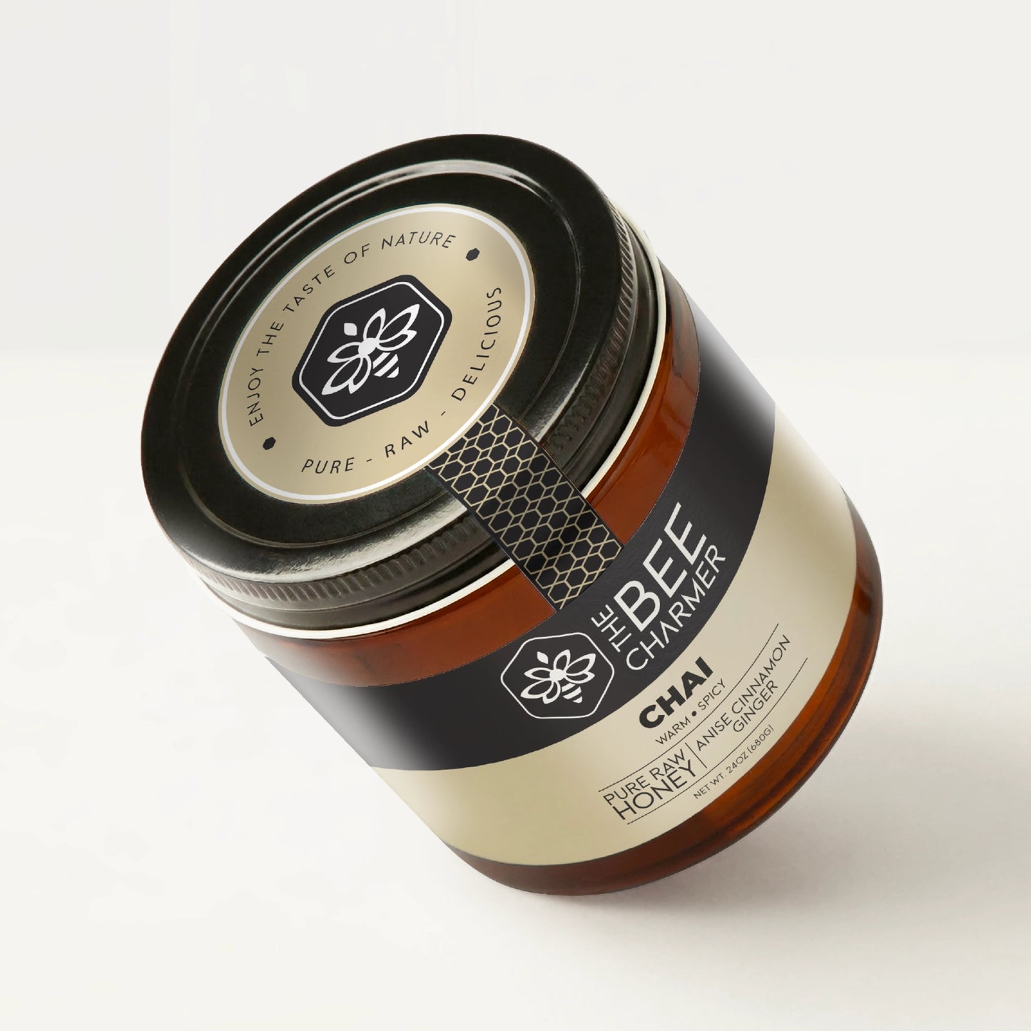 Anise Cinnamon Ginger-infused Chai Honey in a signature Bee Charmer branded 24oz wide-mouth glass jar showing the top of the jar label.