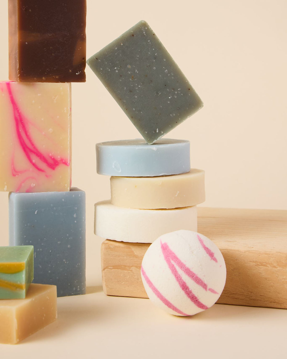 Stacked bar soaps, shampoo and conditioner bars and a fizzing bath bomb