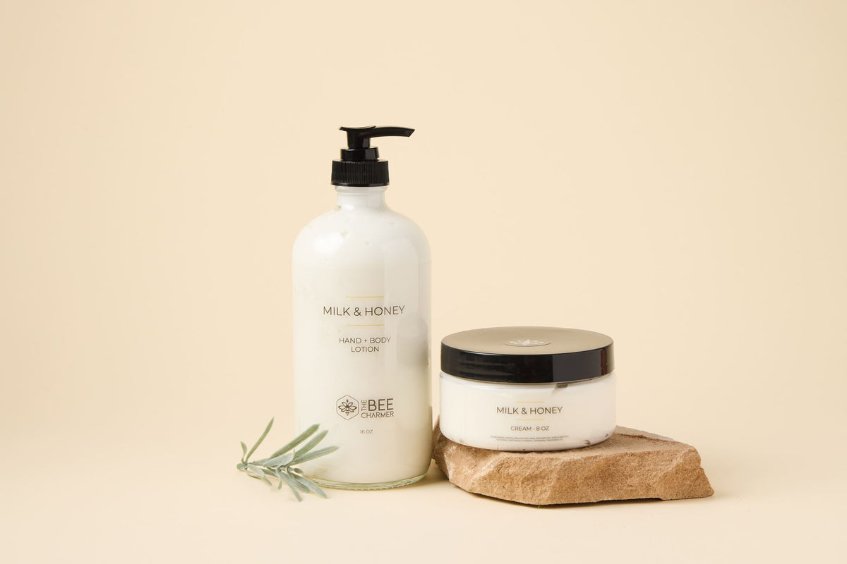 Milk & Honey Lotion & Cream Set: hand & body lotion and cream on a stone slab with fresh rosemary
