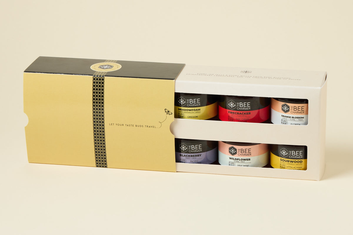 Honey 6-Pack gift box with the gold sleeve slid open to show six raw honey jars in two rows